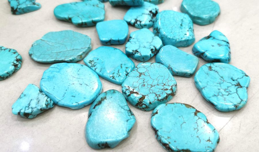 A group of polished blue Larimar cabochons.