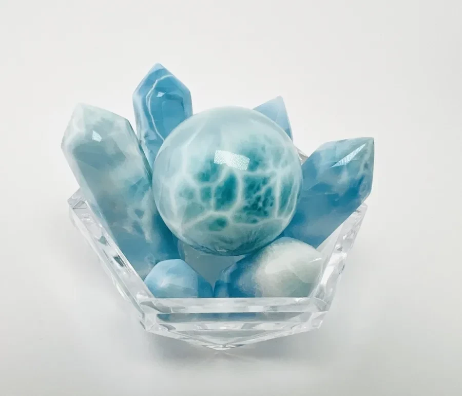 A polished Larimar sphere and towers arranged in a display.
