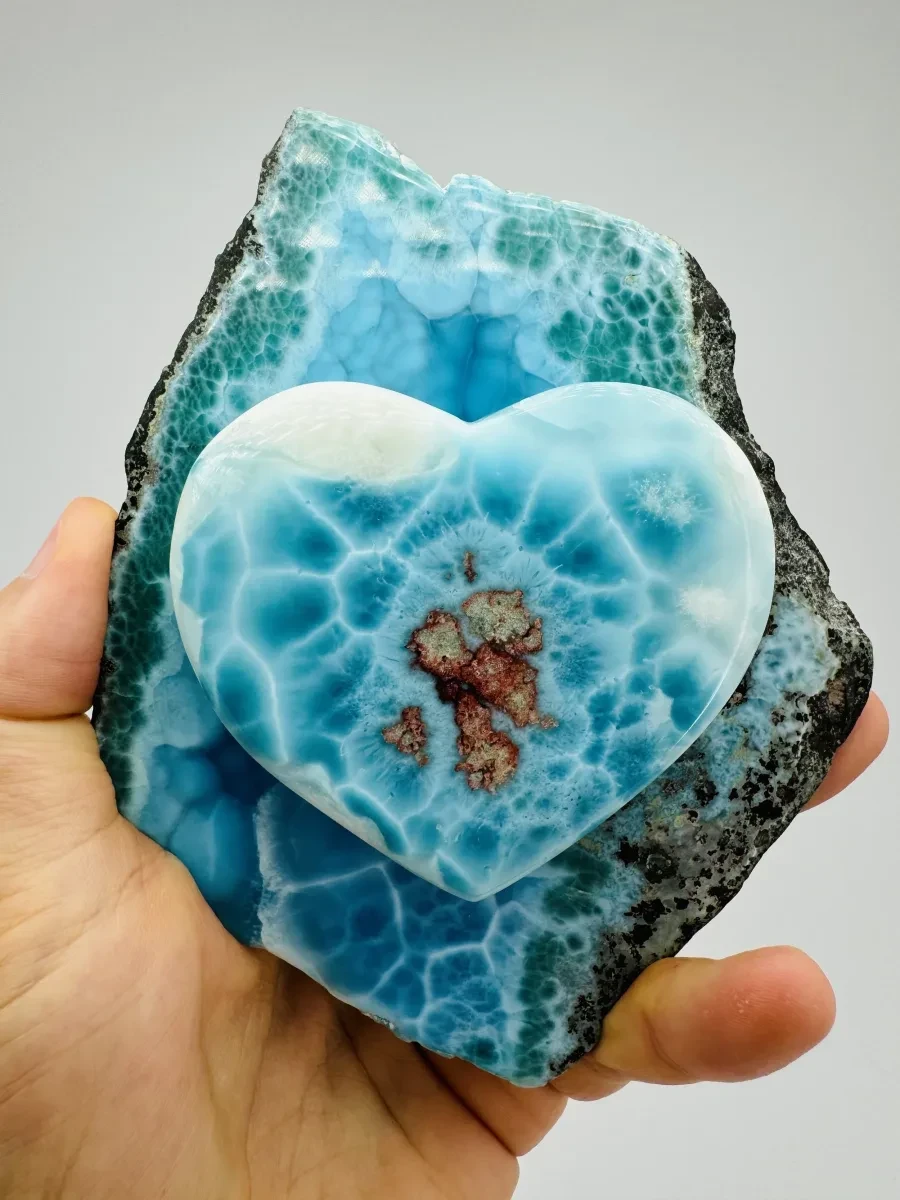 A heart-shaped Larimar piece with distinct natural patterning.