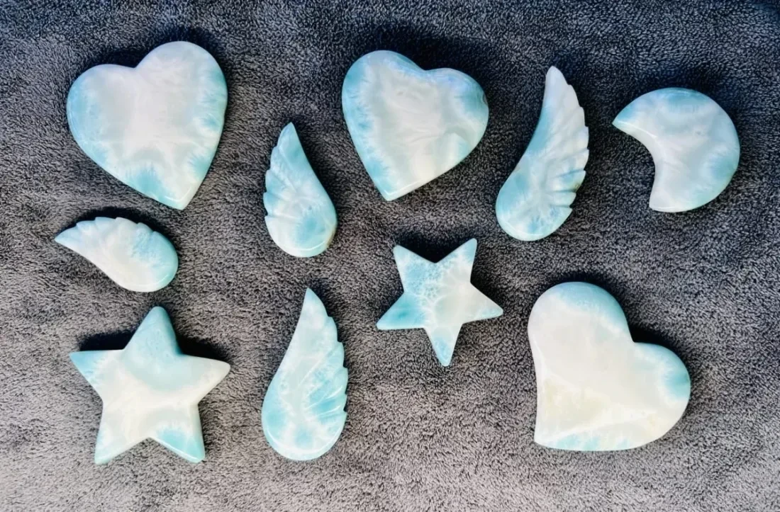 Several finished Larimar forms arranged on a light background.