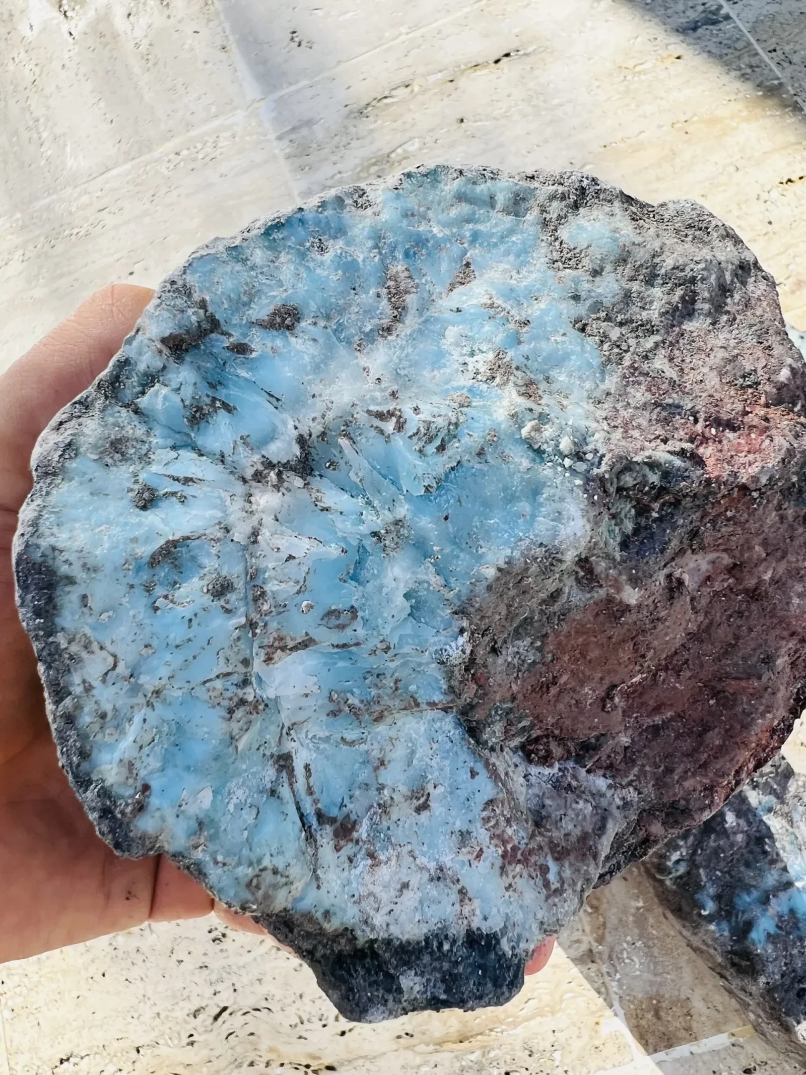 A natural piece of Larimar-bearing rough rock.