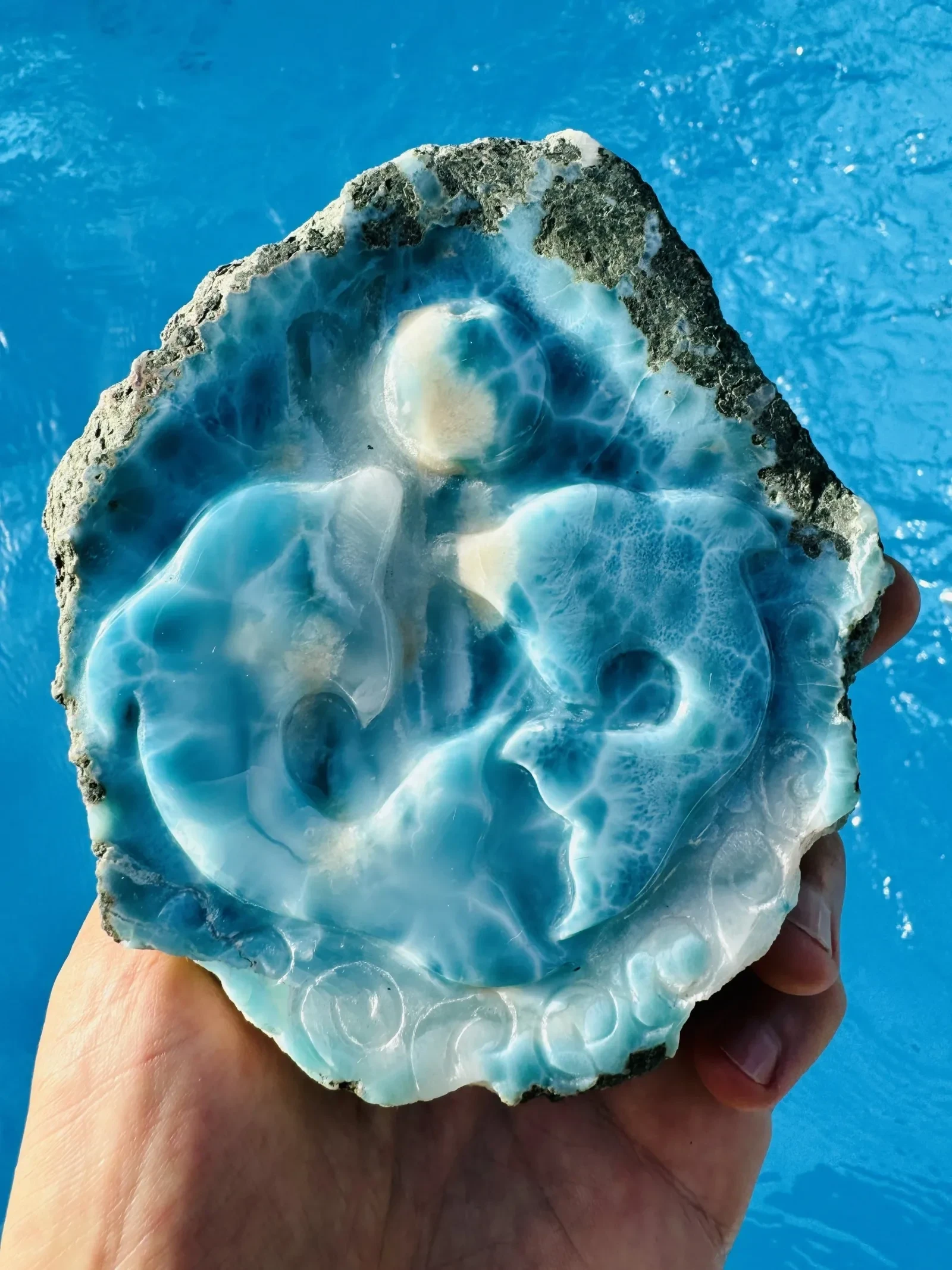 A relief carving shaped into a Larimar specimen.