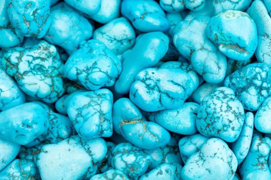 Blue turquoise tumbled stones with dark matrix veining, shown for comparison