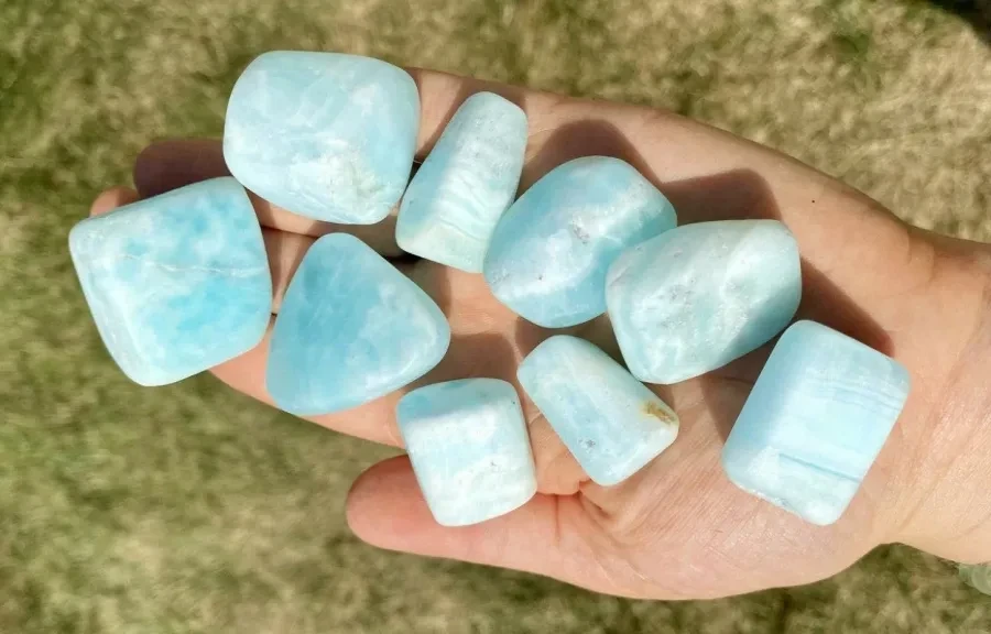 Polished Caribbean calcite tumbled stones, shown for comparison